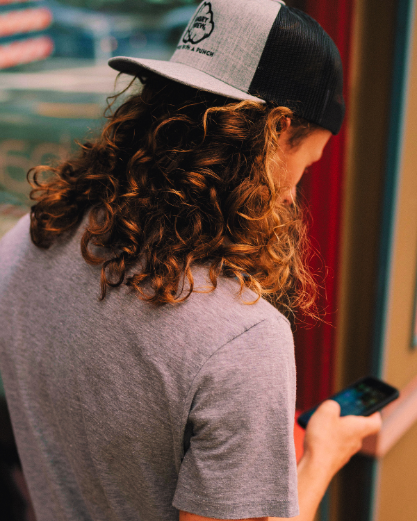 Five Lakes guest with a coffee cup and phone